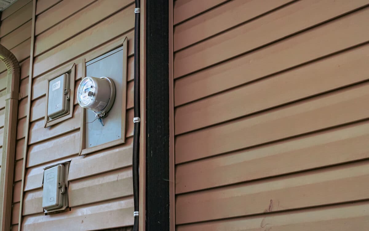AC condenser installed at the side of a house — AC Installation completed in Burnaby, BC by DirectBuy Furnace