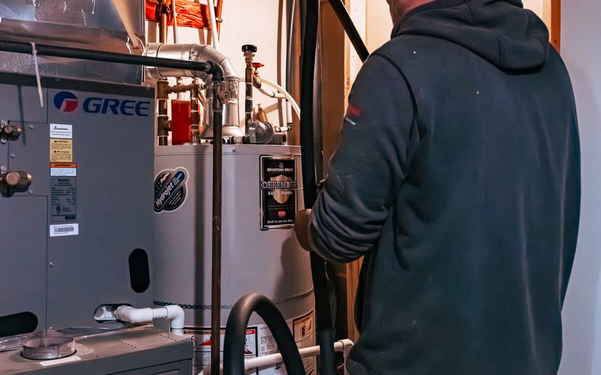 Technician diagnosing a furnace — HVAC installation in Port Coquitlam, BC by DirectBuy Furnace